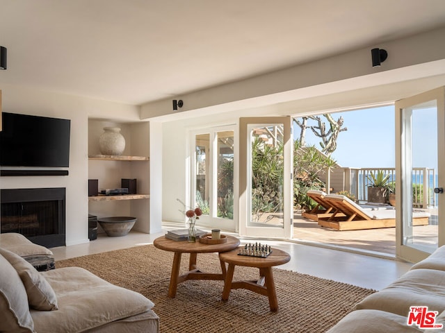 living room featuring a healthy amount of sunlight and built in features