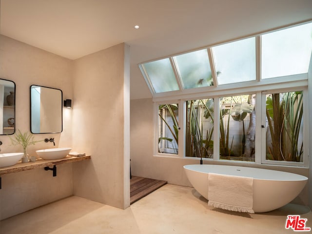 bathroom with vanity and a tub