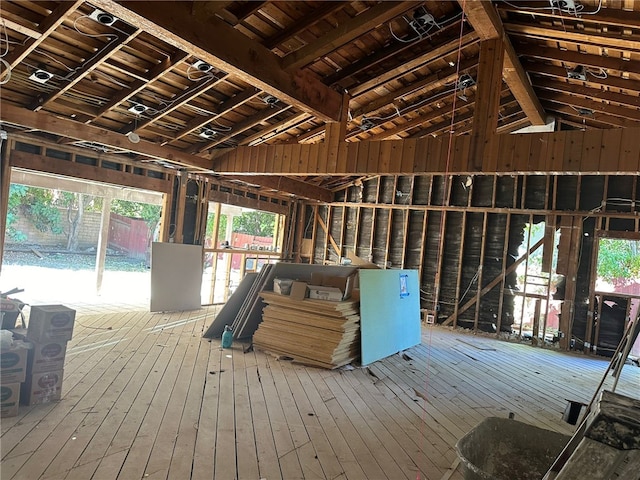 misc room with wood-type flooring, vaulted ceiling, wooden ceiling, and wooden walls