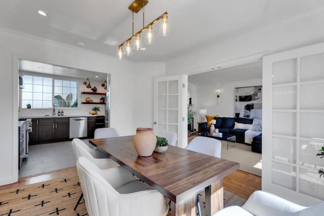 dining room featuring sink and light hardwood / wood-style floors