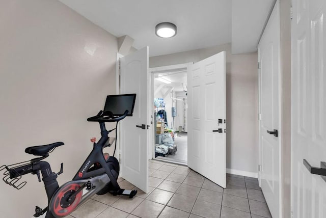 workout room featuring light tile patterned floors