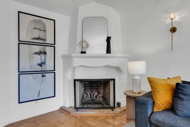 living room featuring parquet floors and a tiled fireplace