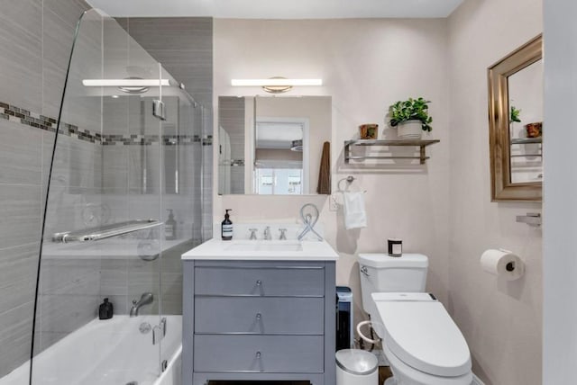 full bathroom with shower / bath combination with glass door, vanity, and toilet