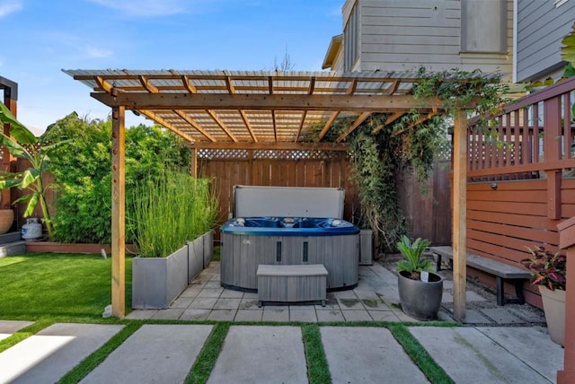 view of patio / terrace featuring a pergola and a hot tub