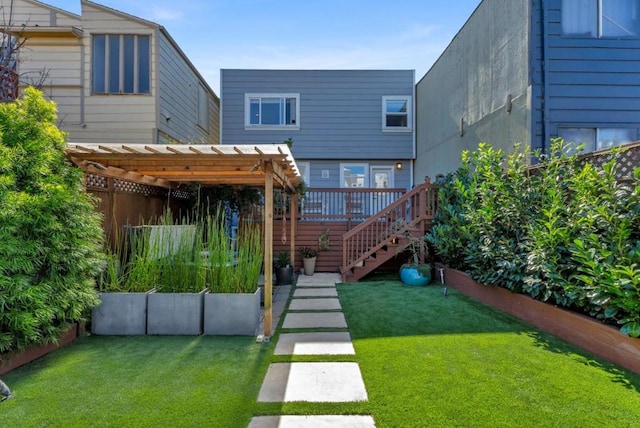 back of house featuring a pergola, a lawn, and a deck