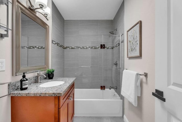 bathroom with vanity and tiled shower / bath combo