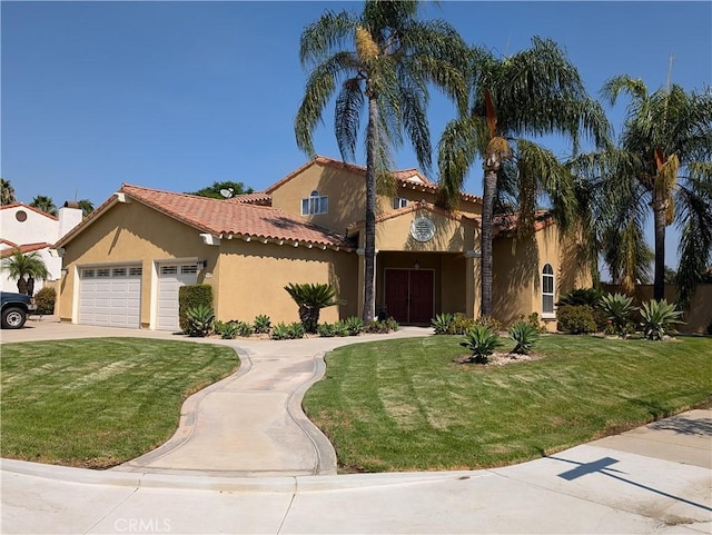 mediterranean / spanish-style house featuring a garage and a front yard