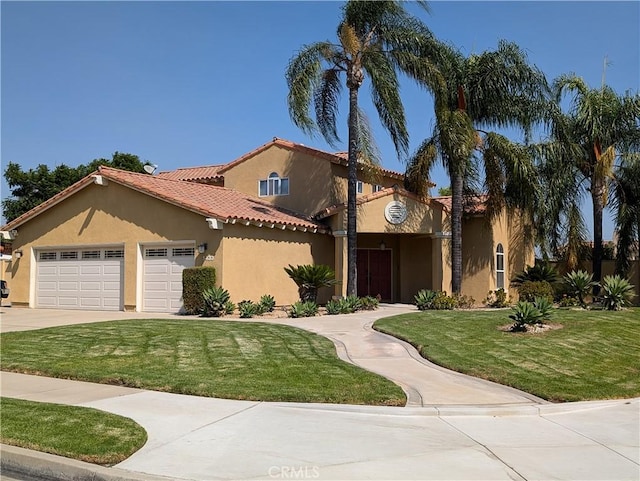 mediterranean / spanish house with a front lawn and a garage