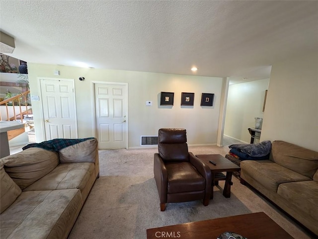 carpeted living room with a textured ceiling