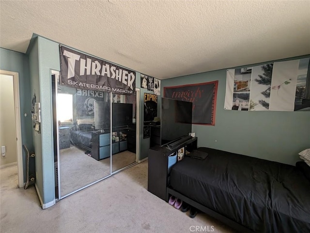 bedroom with light carpet, a textured ceiling, and a closet