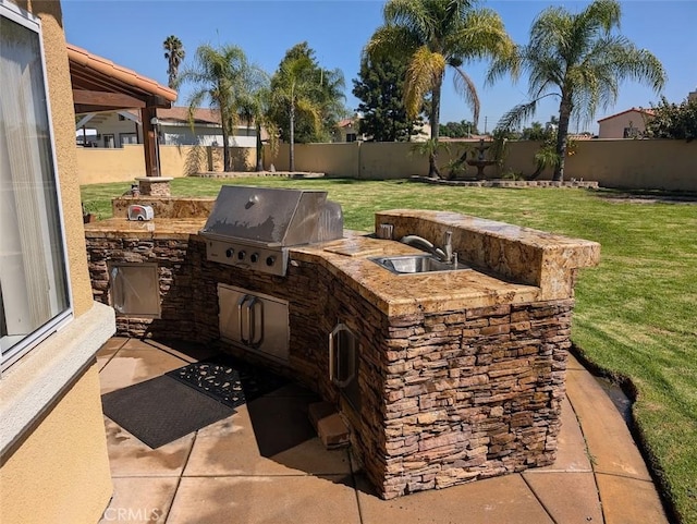 view of patio / terrace featuring sink, a grill, and exterior kitchen