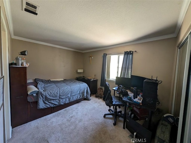 carpeted bedroom with a textured ceiling and ornamental molding