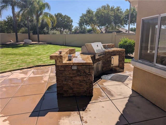 view of patio / terrace with an outdoor kitchen and a grill