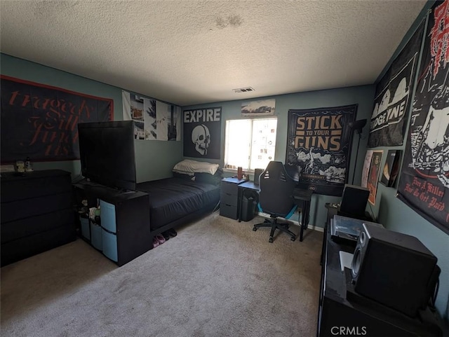 bedroom featuring carpet floors and a textured ceiling