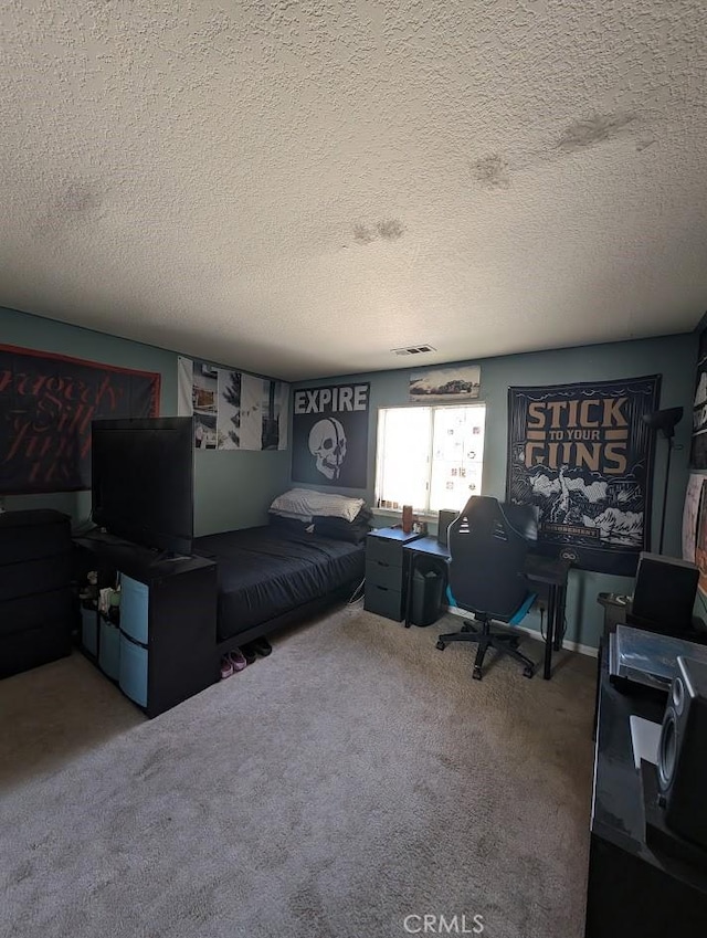 bedroom featuring a textured ceiling and carpet floors