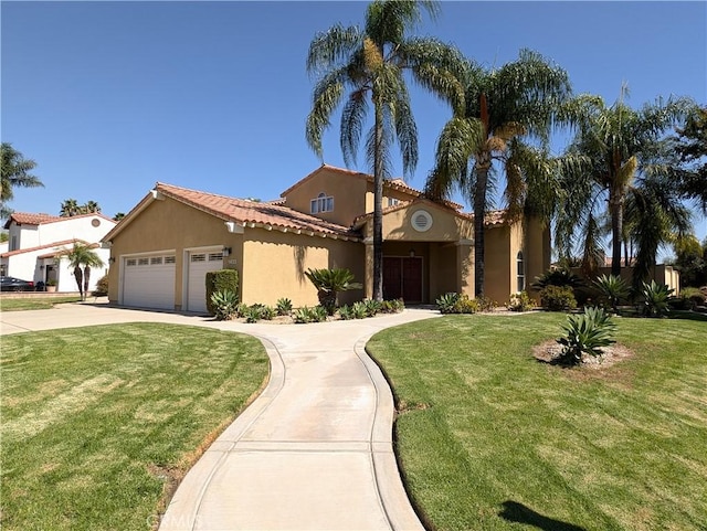 mediterranean / spanish-style home with a front lawn and a garage