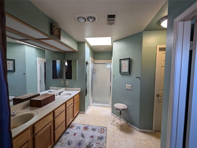 bathroom with tile patterned floors, vanity, and walk in shower