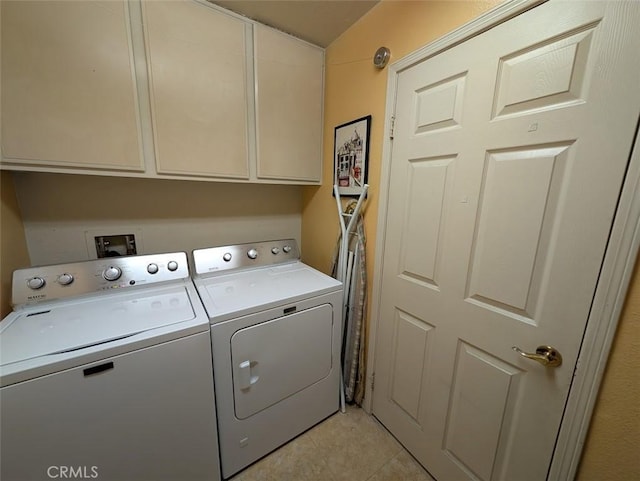 laundry room with separate washer and dryer, light tile patterned floors, and cabinets