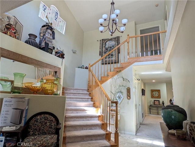 staircase featuring carpet flooring, high vaulted ceiling, and a notable chandelier