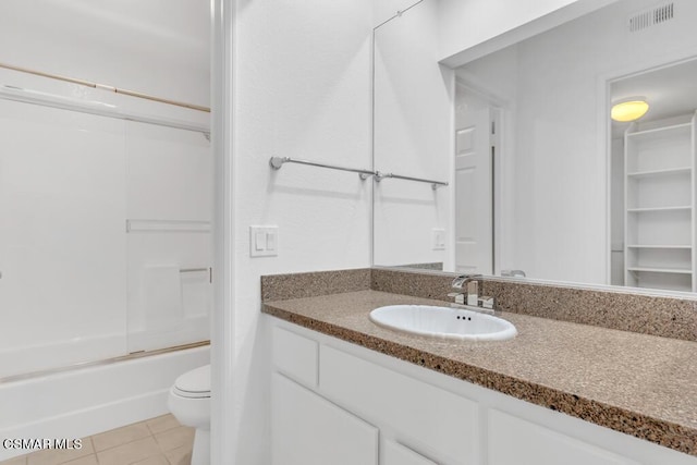 full bathroom featuring tile patterned floors, vanity, toilet, and shower / bath combination with glass door