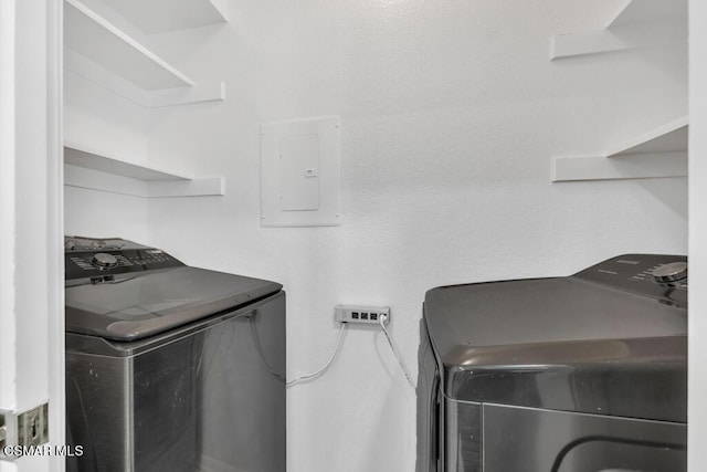 laundry room with washing machine and dryer and electric panel