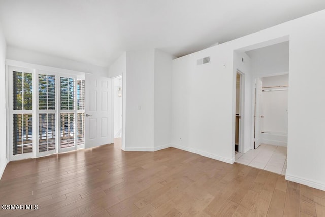 unfurnished room with light hardwood / wood-style flooring