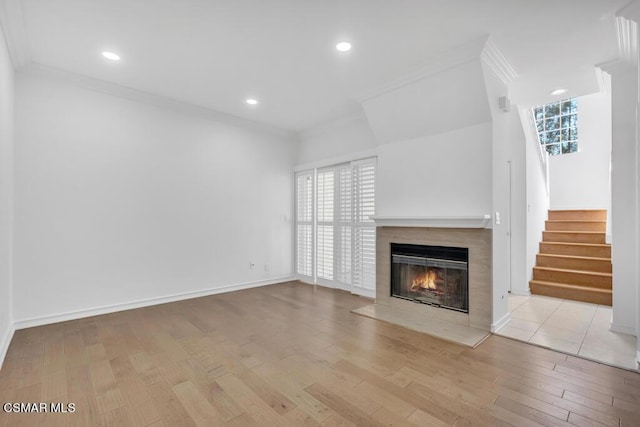 unfurnished living room featuring crown molding and light hardwood / wood-style flooring