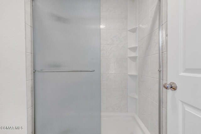 bathroom with a shower with shower door