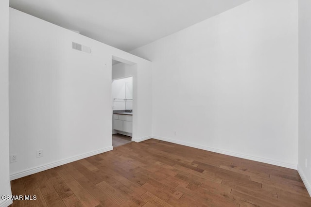 spare room with hardwood / wood-style flooring