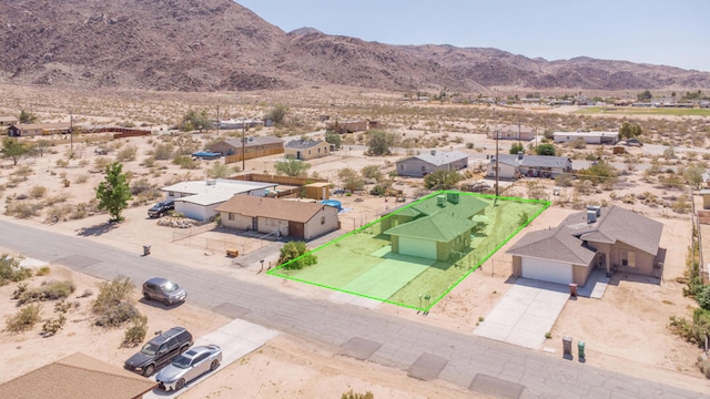 birds eye view of property featuring a mountain view