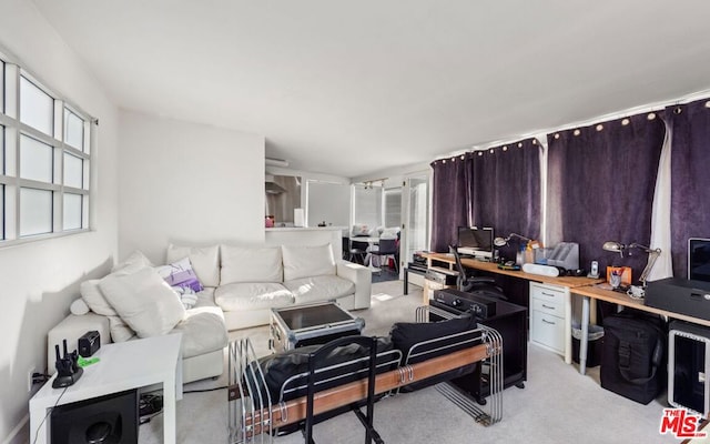 carpeted living room featuring built in desk