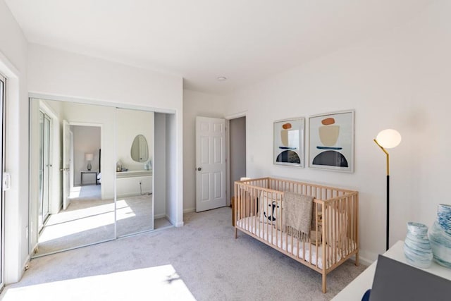 carpeted bedroom with a crib and a closet