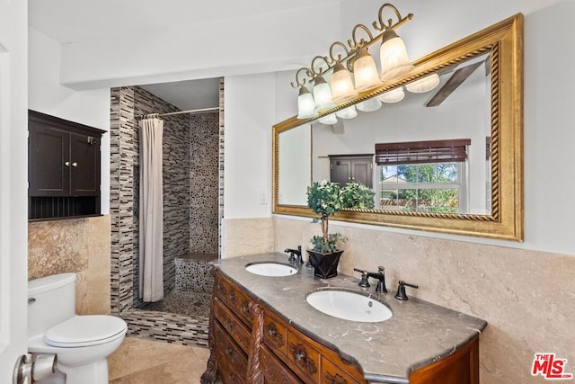 bathroom with toilet, a shower with shower curtain, tile walls, tile patterned floors, and vanity