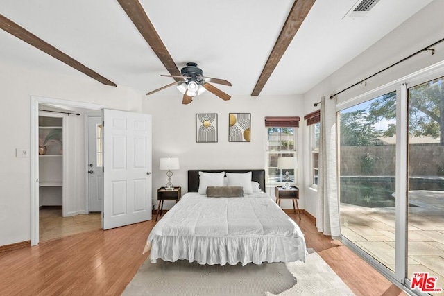 bedroom with ceiling fan, access to outside, light wood-type flooring, and beamed ceiling