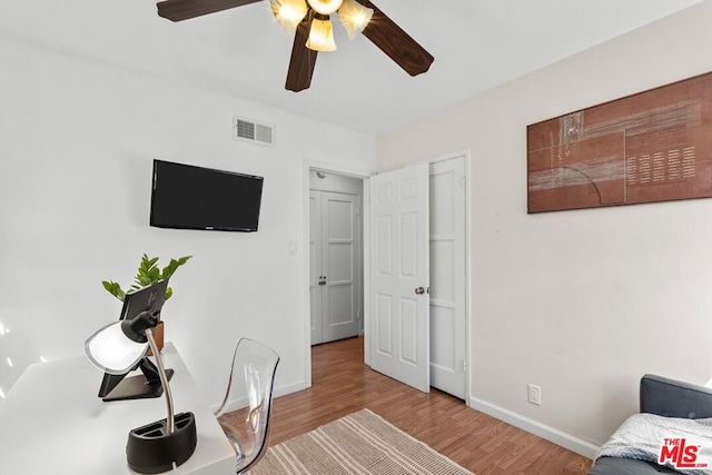 home office with ceiling fan and light wood-type flooring