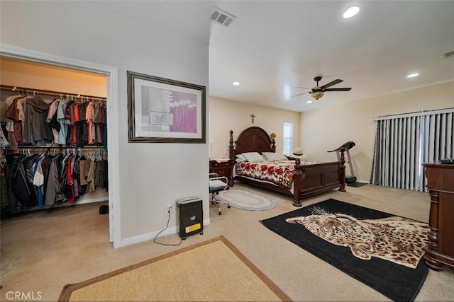 carpeted bedroom with ceiling fan and a closet