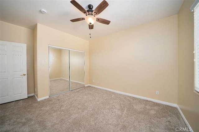 unfurnished bedroom with carpet floors, a closet, and ceiling fan