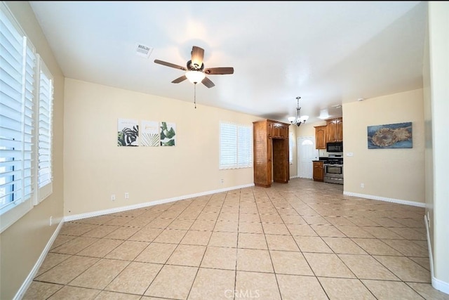 unfurnished living room with light tile patterned floors and ceiling fan with notable chandelier