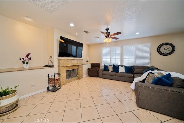 living room with ceiling fan and light tile patterned flooring