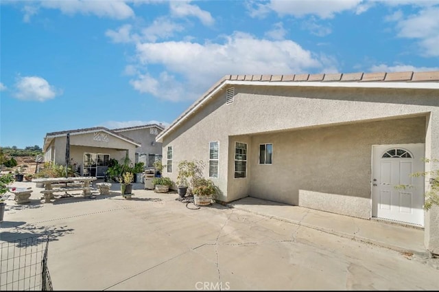 rear view of house featuring a patio area