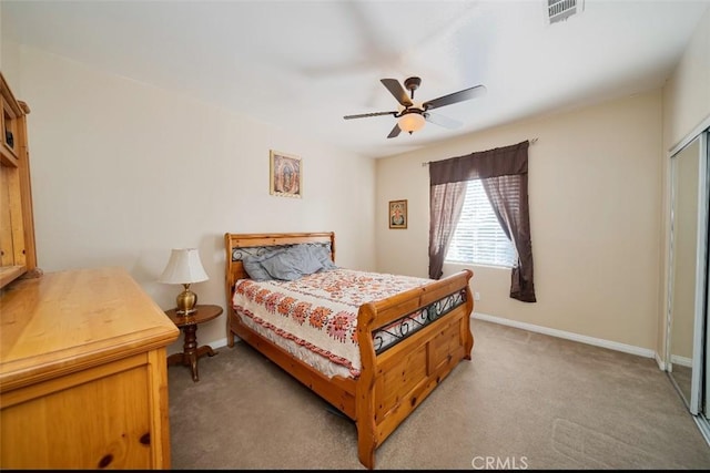 carpeted bedroom with ceiling fan and a closet