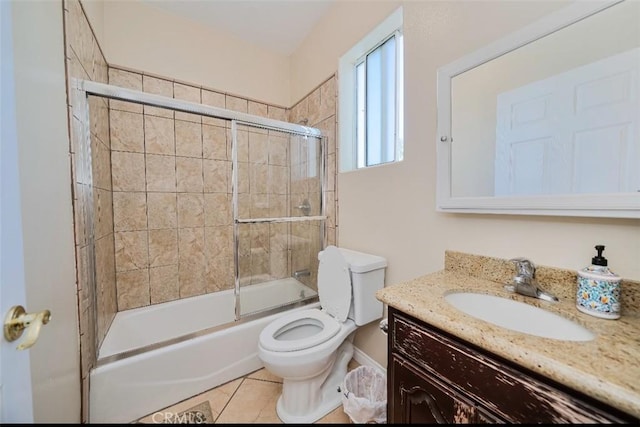 full bathroom with tile patterned flooring, vanity, toilet, and enclosed tub / shower combo