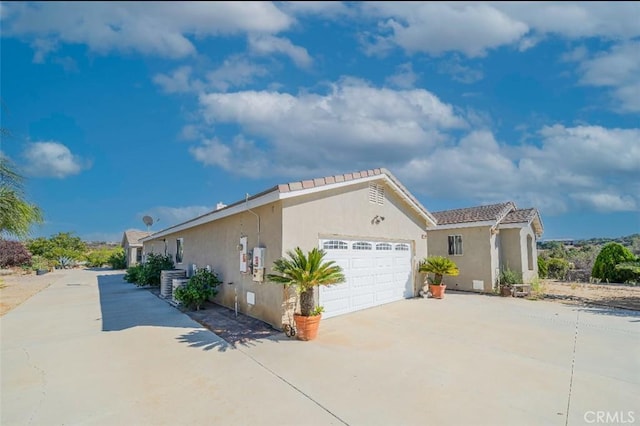 view of front of house featuring central AC and a garage