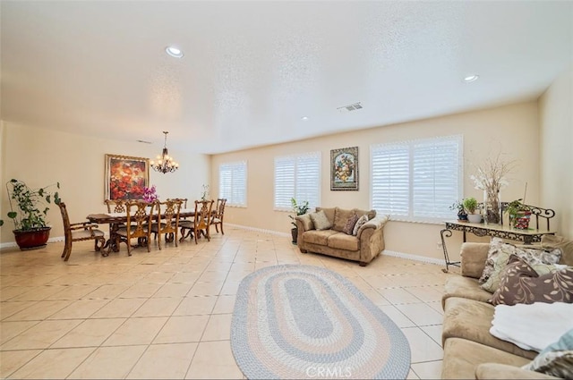 living room with a notable chandelier and light tile patterned flooring