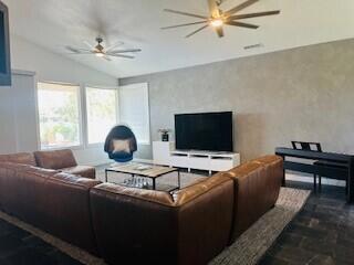 living room with lofted ceiling and ceiling fan