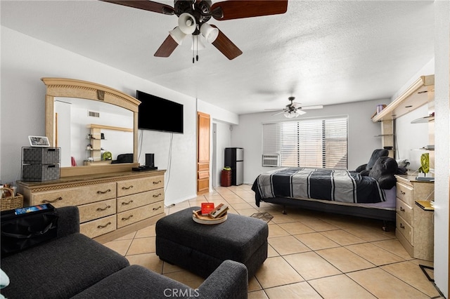 bedroom featuring a textured ceiling, light tile patterned flooring, and ceiling fan