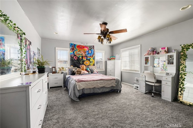 bedroom with ceiling fan and dark colored carpet