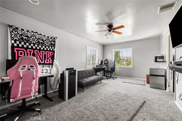 carpeted office featuring ceiling fan and crown molding