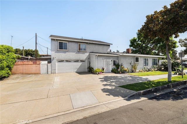 view of front of property with a garage and a front lawn