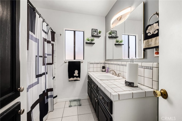 bathroom featuring lofted ceiling, decorative backsplash, tile patterned flooring, and vanity